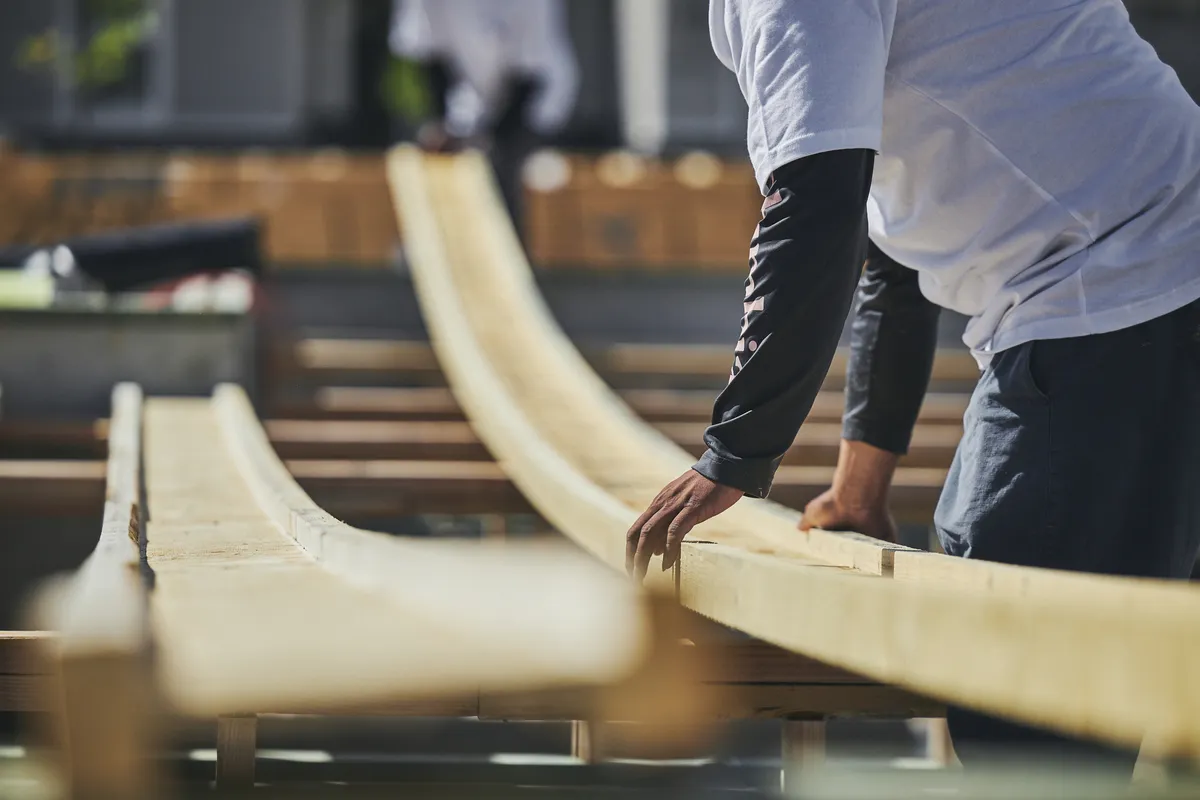 Two workers building a deck with PWT products