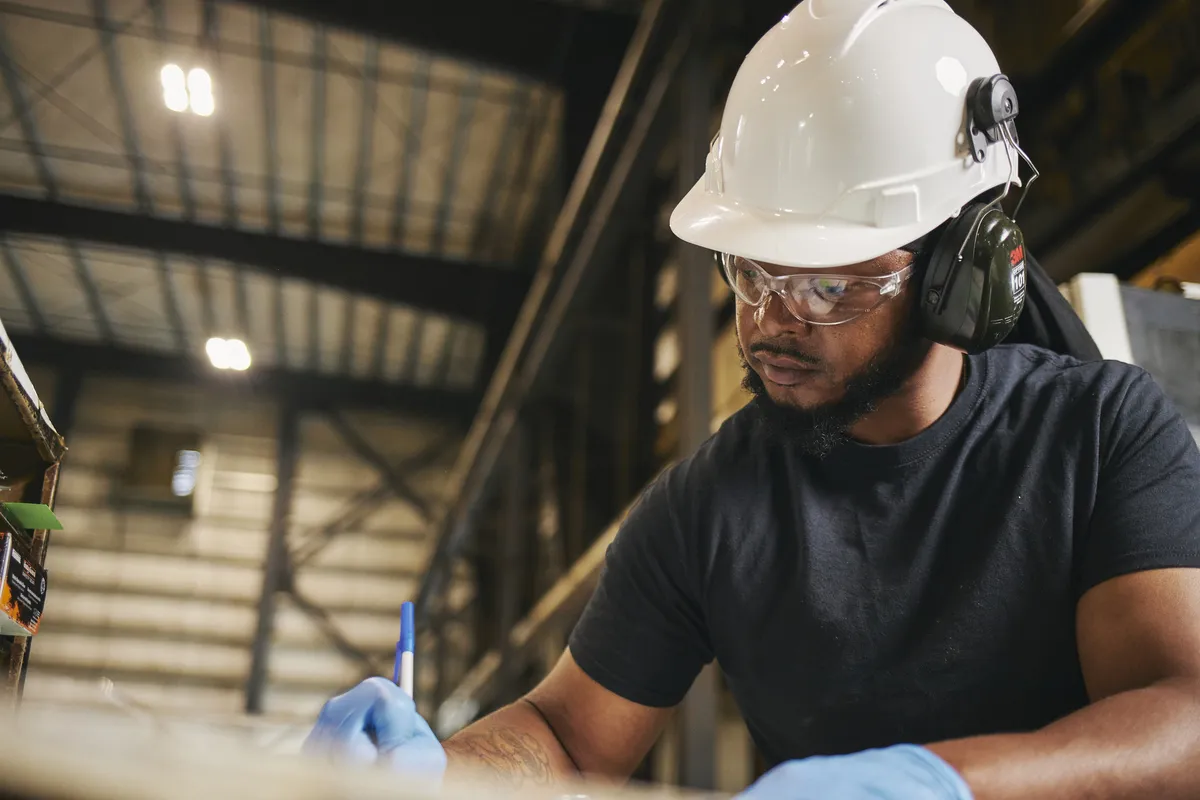 Man in hard hat working in PWT mill