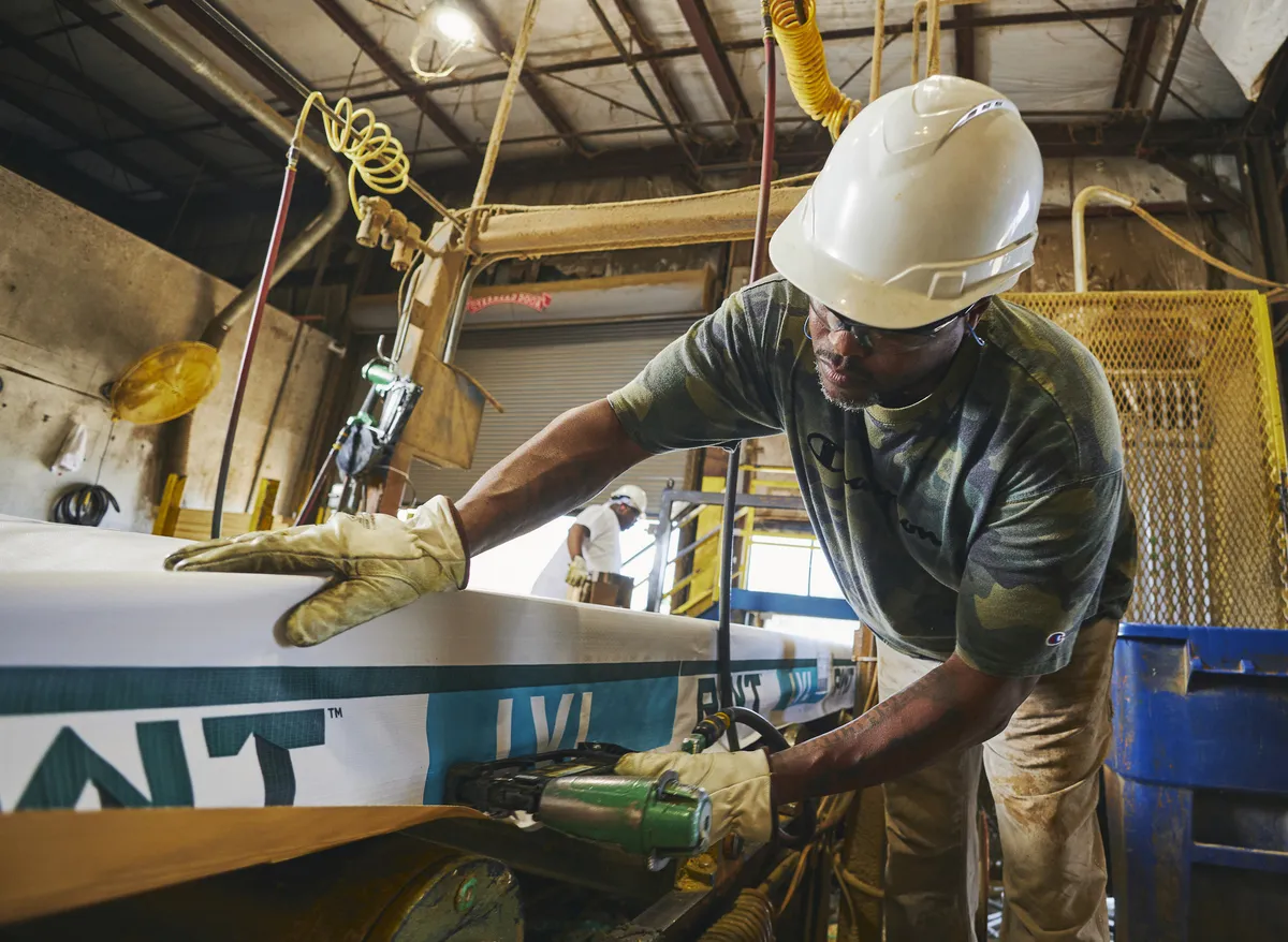 Man working in a PWT mill handing product