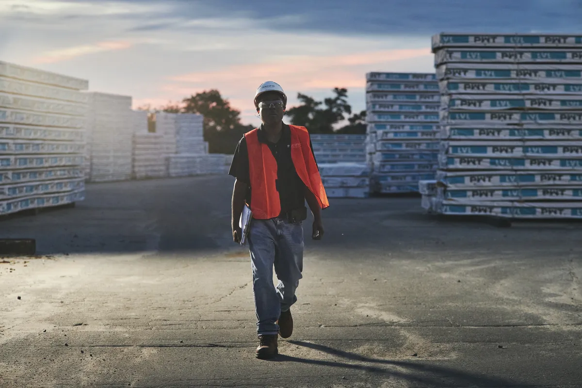 Man standing among PWT product outside on a lot