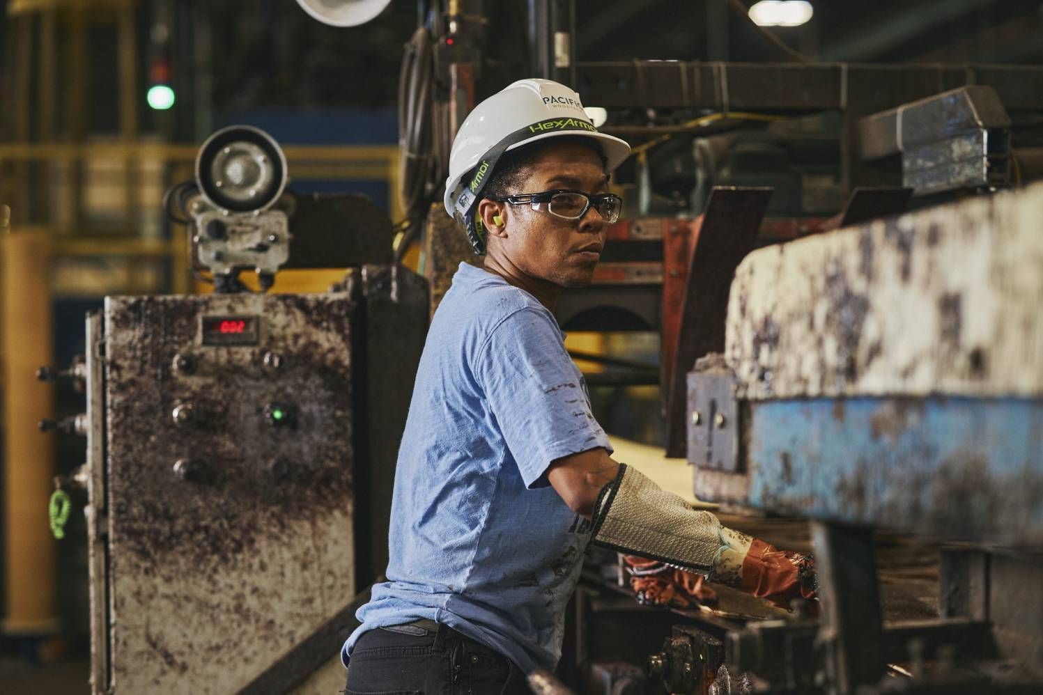 woman working on a machine at a factory